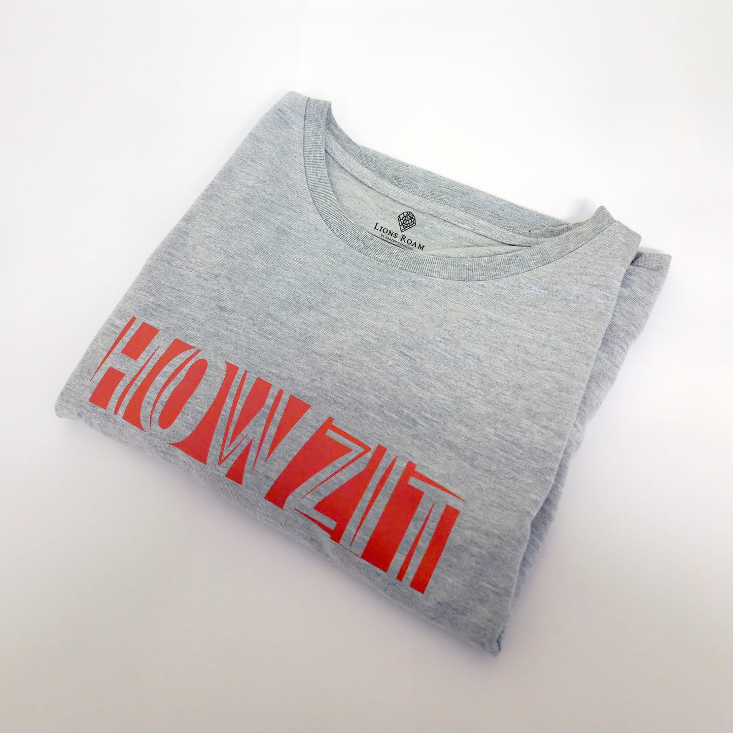 A Grey t-shirt with the phrase "Howzit" printed in Red.