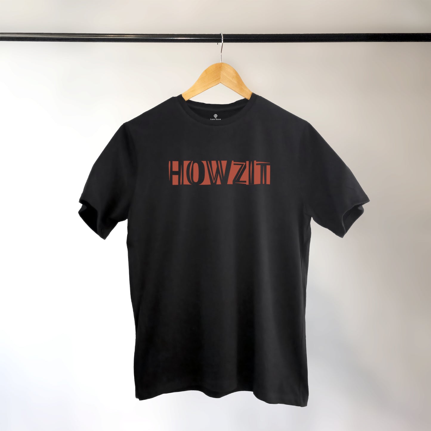 A black t-shirt with the phrase "Howzit" printed in Red.