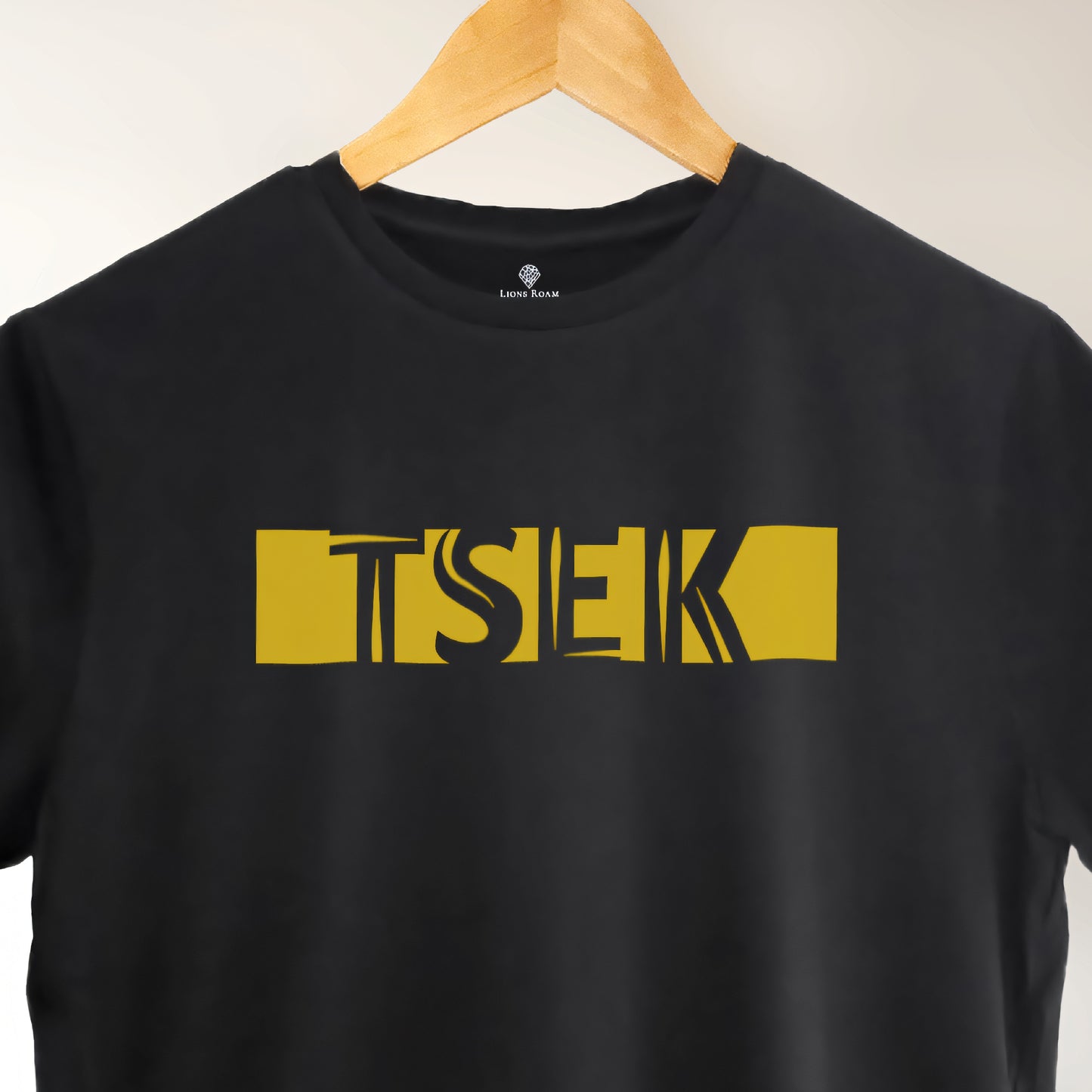A black t-shirt with the phrase "Tsek" printed in Yellow.