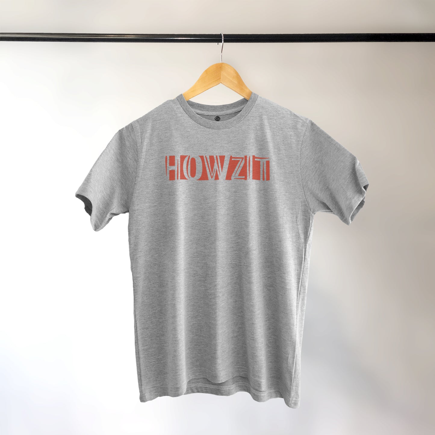A Grey t-shirt with the phrase "Howzit" printed in Red.