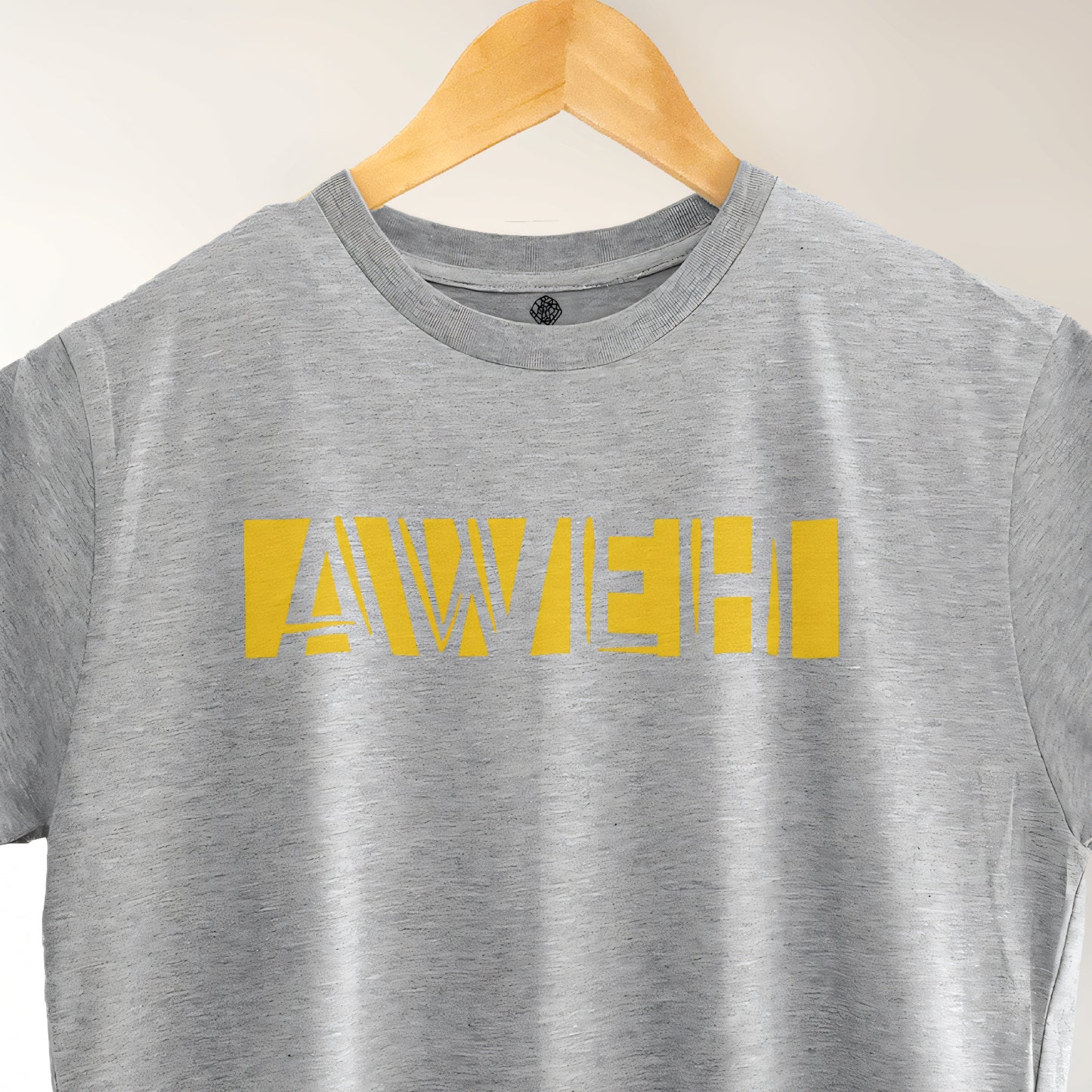 A Grey t-shirt with the phrase "Aweh" printed in Yellow.