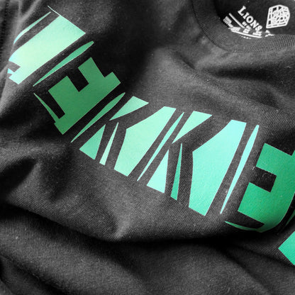 A black t-shirt with the phrase "Lekker" printed in Green.