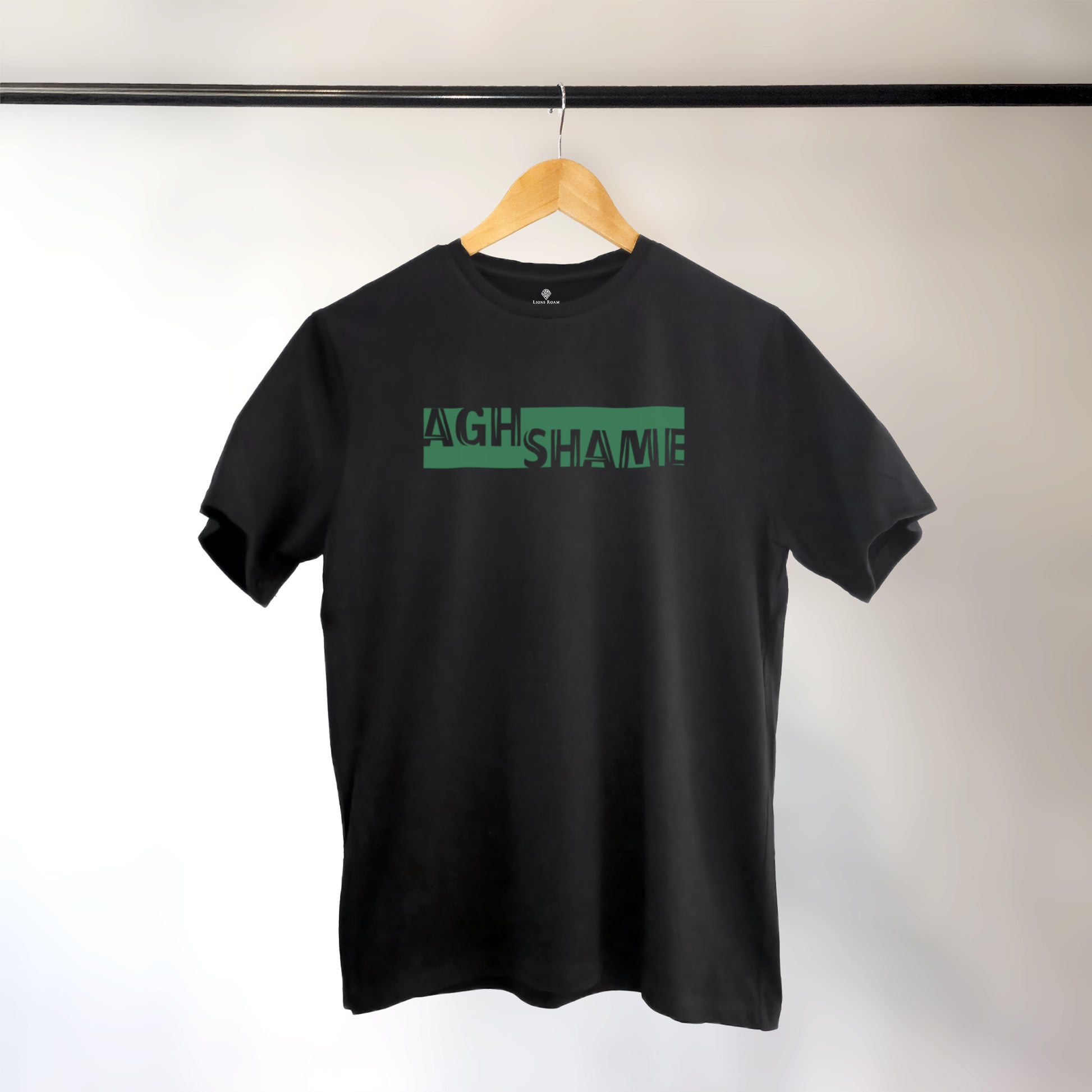 A black t-shirt with the phrase "Ag Shame" printed in Green.