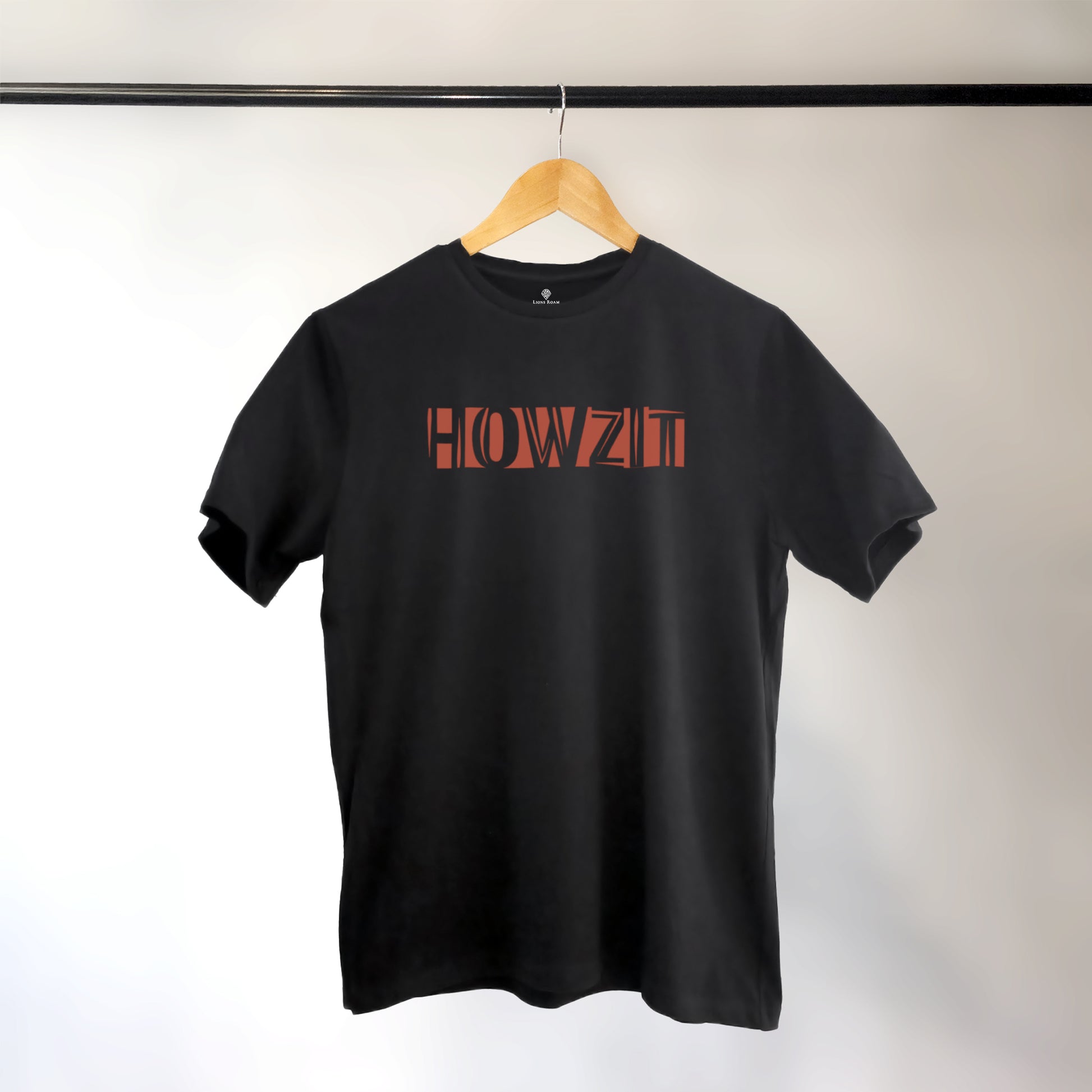 A black t-shirt with the phrase "Howzit" printed in Red.