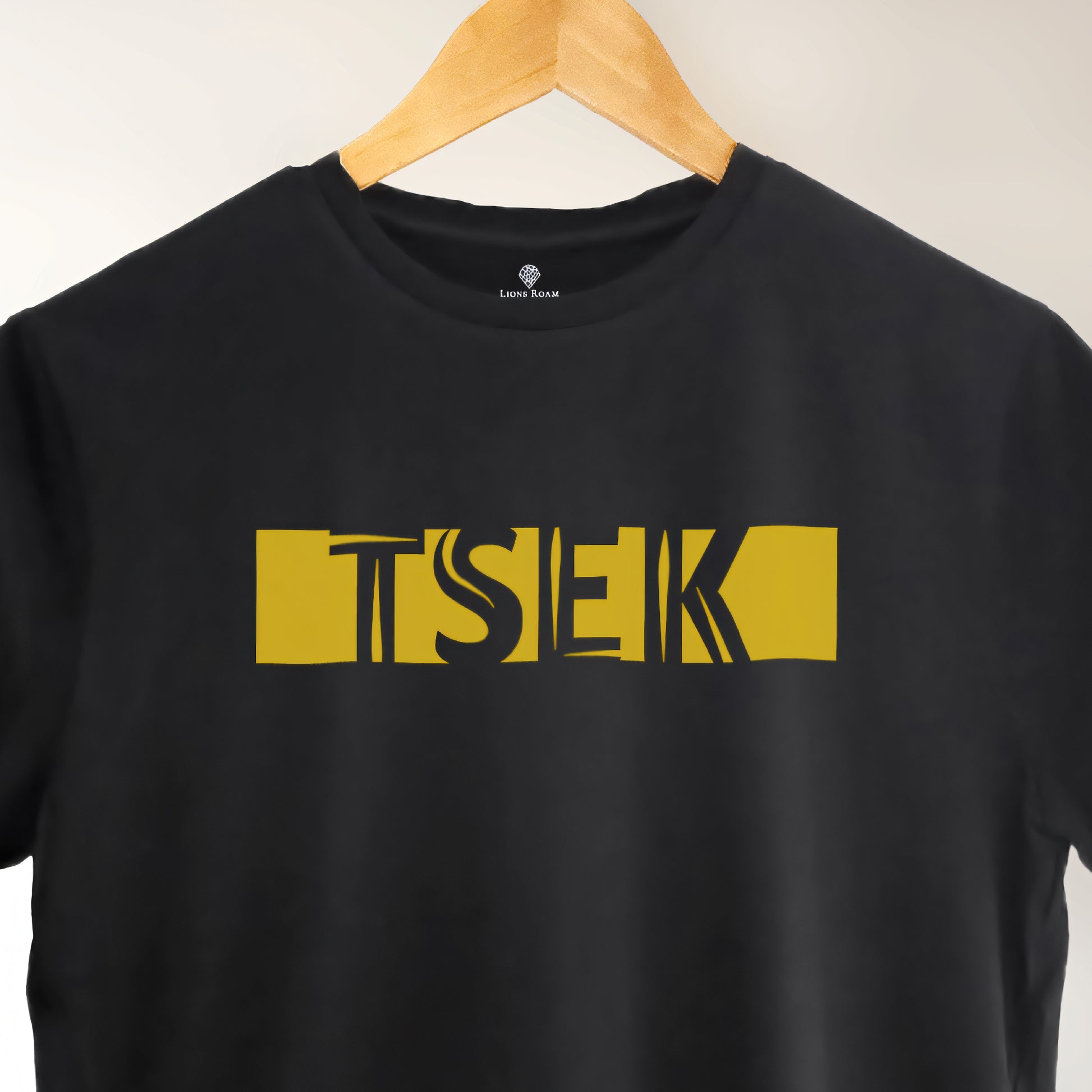 A black t-shirt with the phrase "Tsek" printed in Yellow.