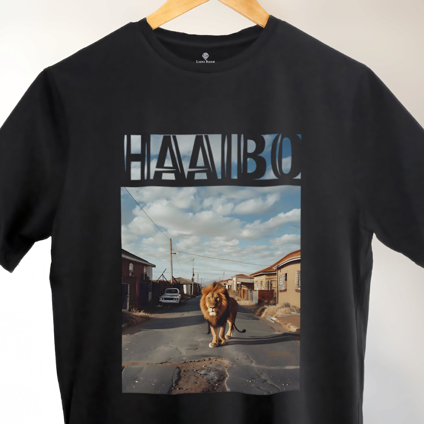 A Black t-shirt with the phrase "Haaibo" printed in the sky, with a lion roaming the streets of africa.