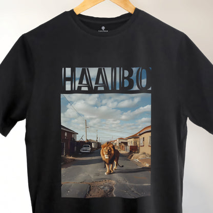 A Black t-shirt with the phrase "Haaibo" printed in the sky, with a lion roaming the streets of africa.