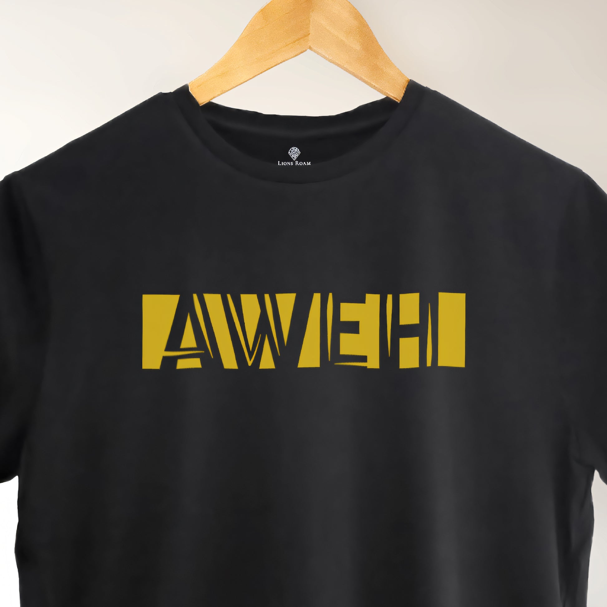A black t-shirt with the phrase "Aweh" printed in Yellow.
