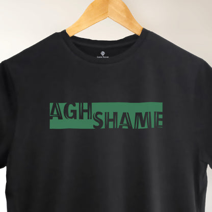 A black t-shirt with the phrase "Agh Shame" printed in Green.