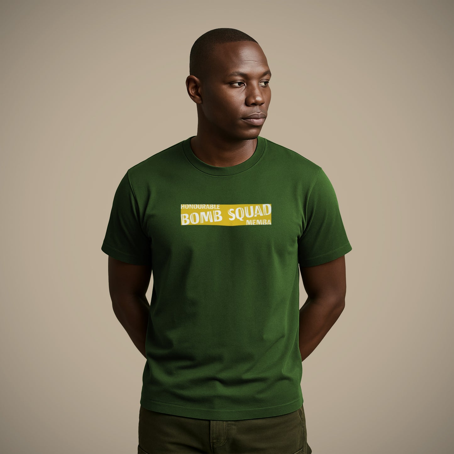 A man wearing a green Lions Roam t-shirt with the phrase 'Honourable Bomb Squad Memba' printed boldly on the front. He stands confidently with a serious expression, representing strength, humour, and South African rugby culture.