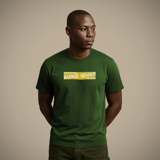 A man wearing a green Lions Roam t-shirt with the phrase 'Honourable Bomb Squad Memba' printed boldly on the front. He stands confidently with a serious expression, representing strength, humour, and South African rugby culture.