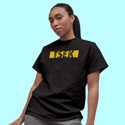 A black t-shirt with the phrase "Tsek" printed in Yellow.