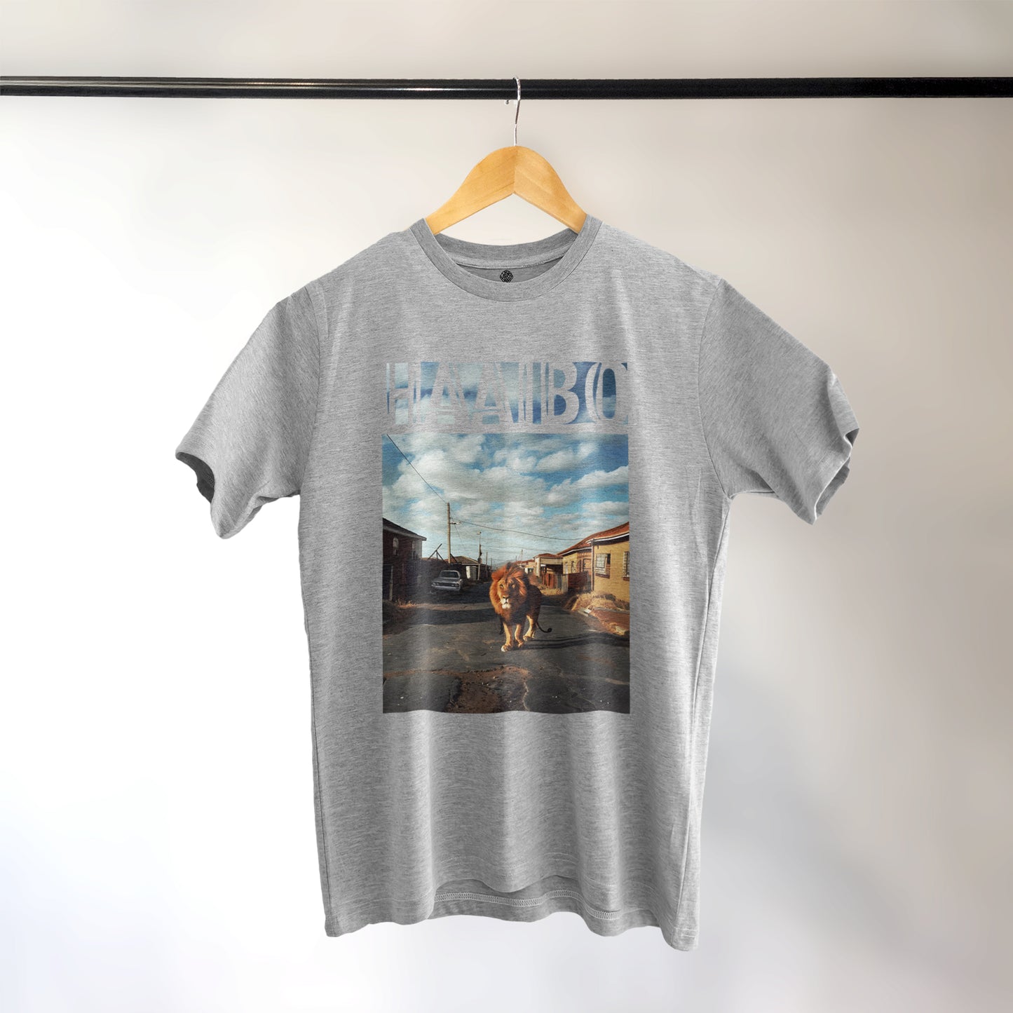 A Grey t-shirt with the phrase "Haaibo" printed in the sky, with a lion roaming the streets of africa.