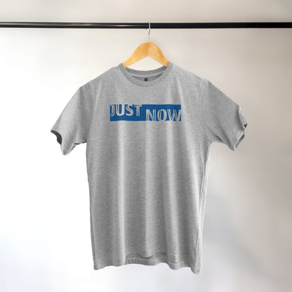 A Grey t-shirt with the phrase "Just Now" printed in Blue.