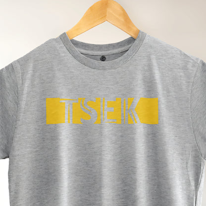 A Grey t-shirt with the phrase "Tsek" printed in Yellow.