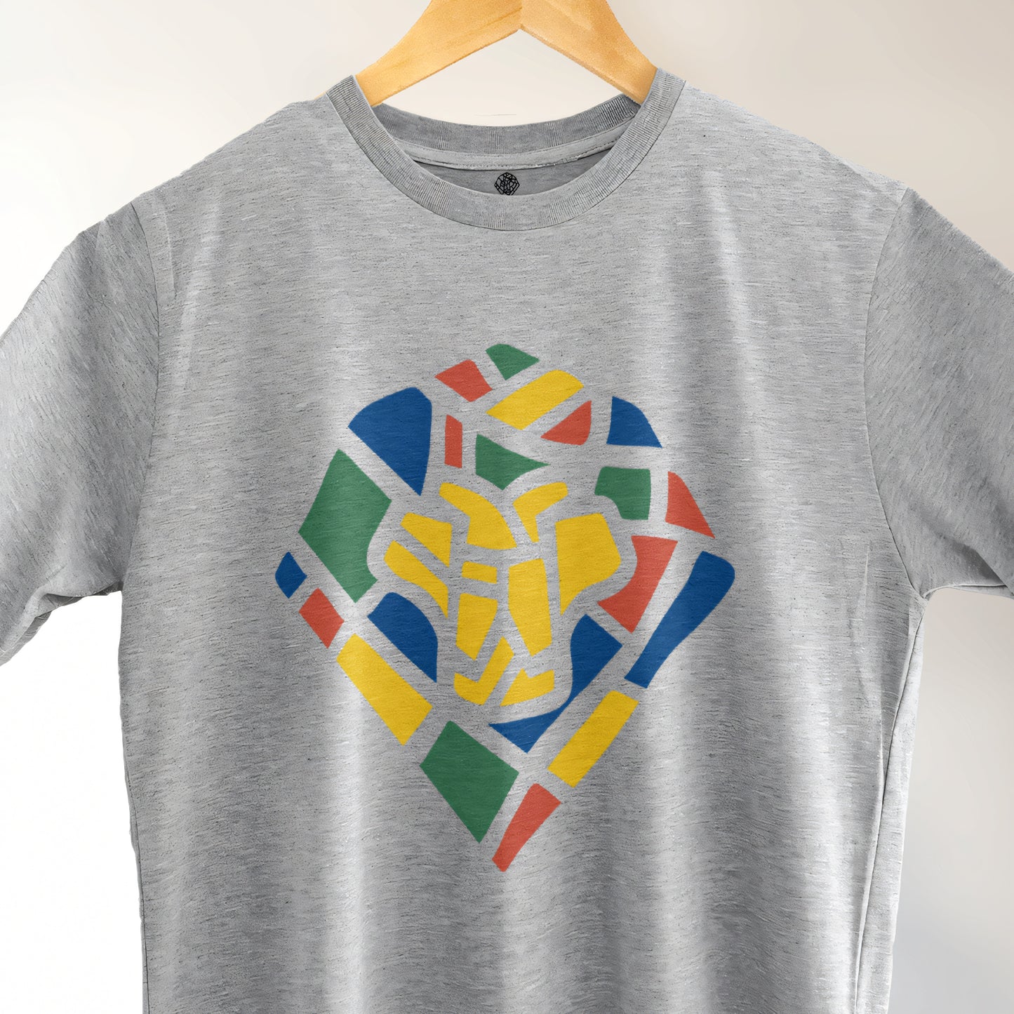 A Grey t-shirt with the Lions Roam Icon printed.