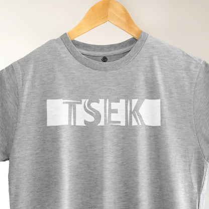 A Grey t-shirt with the phrase "Tsek" printed in White.