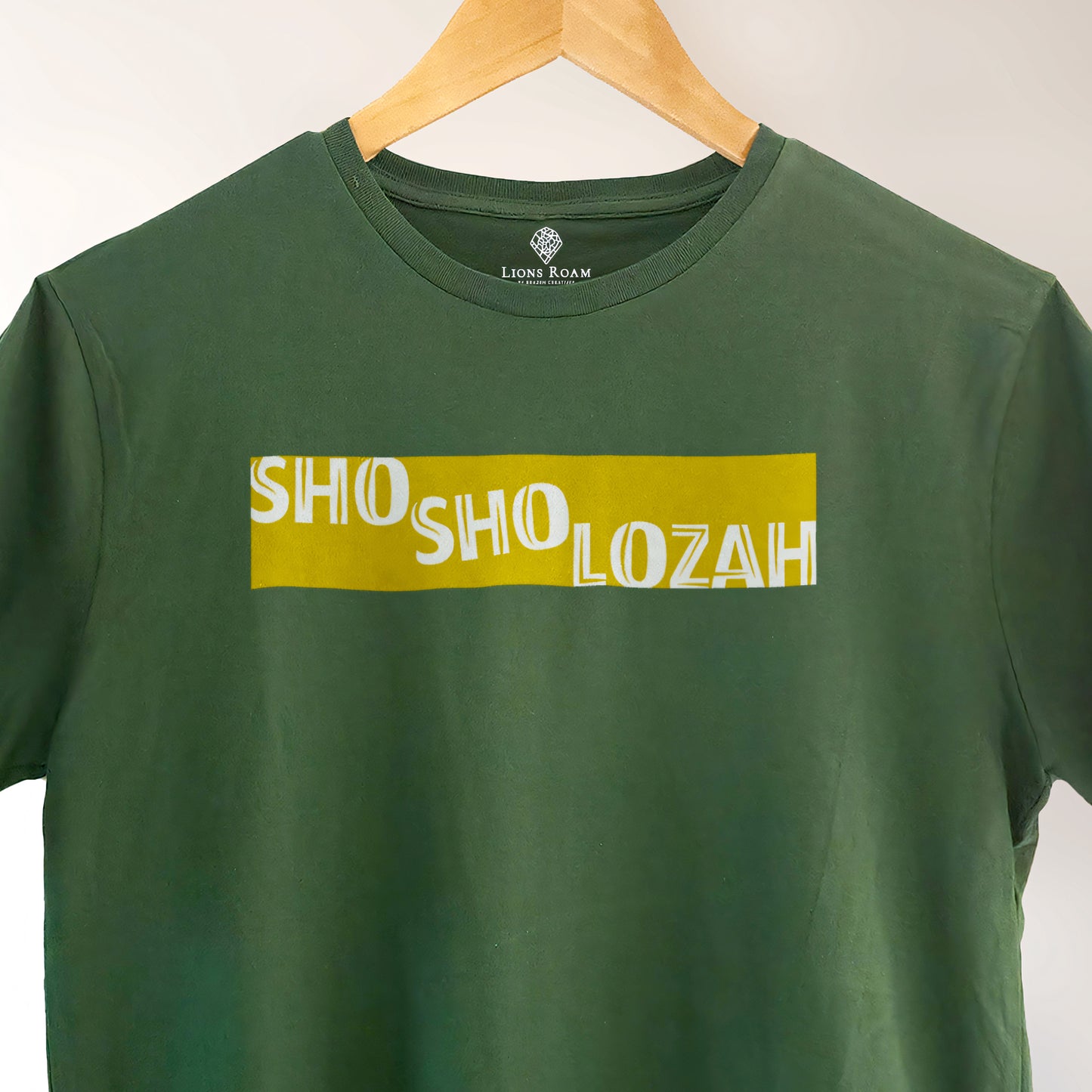 A Green t-shirt with the Phrase  "Shosholozah" printed in Yellow.