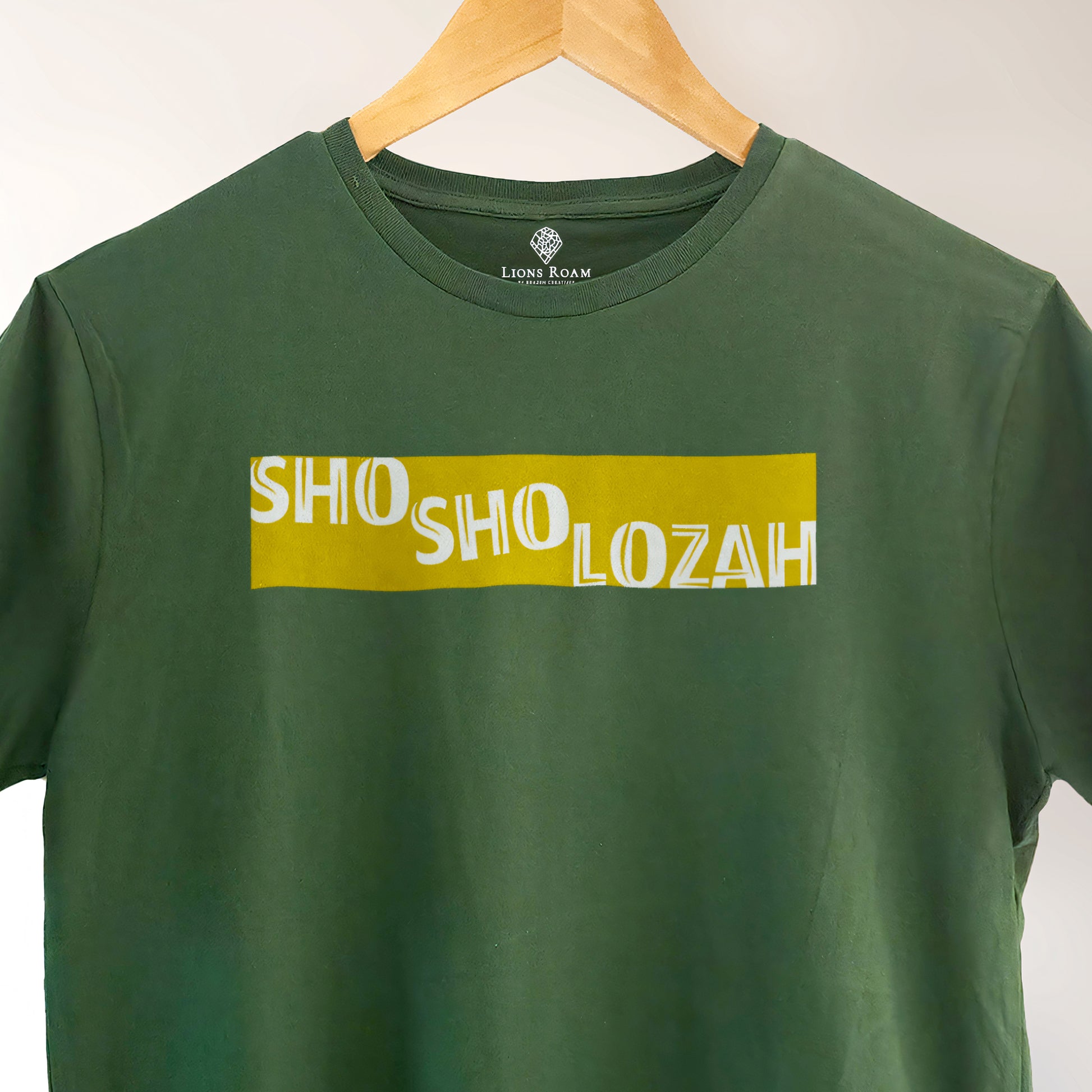 A Green t-shirt with the Phrase  "Shosholozah" printed in Yellow.