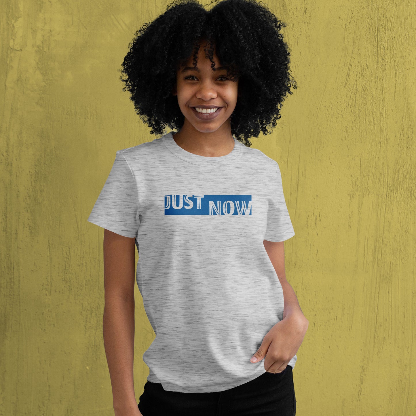 A Grey t-shirt with the phrase "Just Now" printed in Blue.